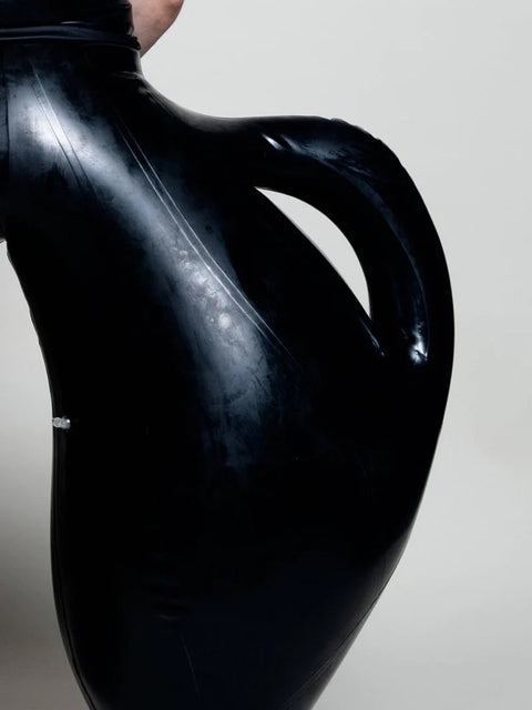 A person wearing black inflatable trousers shaped like a vase with handles at the waist with Tank top