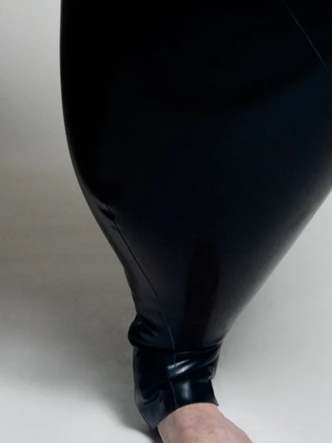 A person wearing black inflatable trousers shaped like a vase with handles at the waist with Tank top
