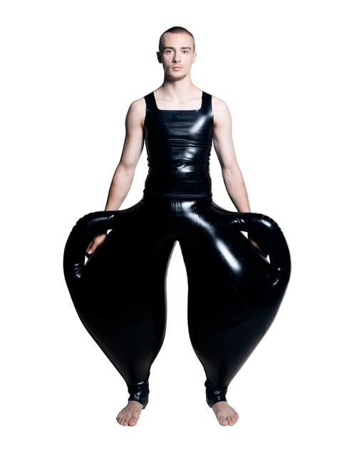 A person wearing black inflatable trousers shaped like a vase with handles at the waist with Tank top
