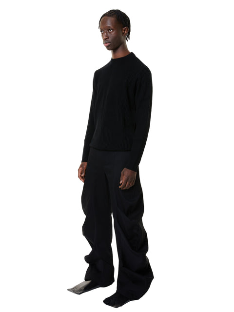 Person wearing a black denim outfit on a white background
