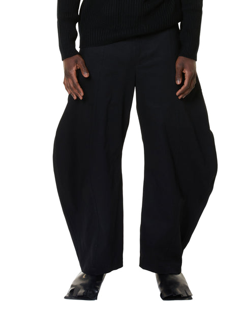 Black wide-leg pants worn by a person on a white background
