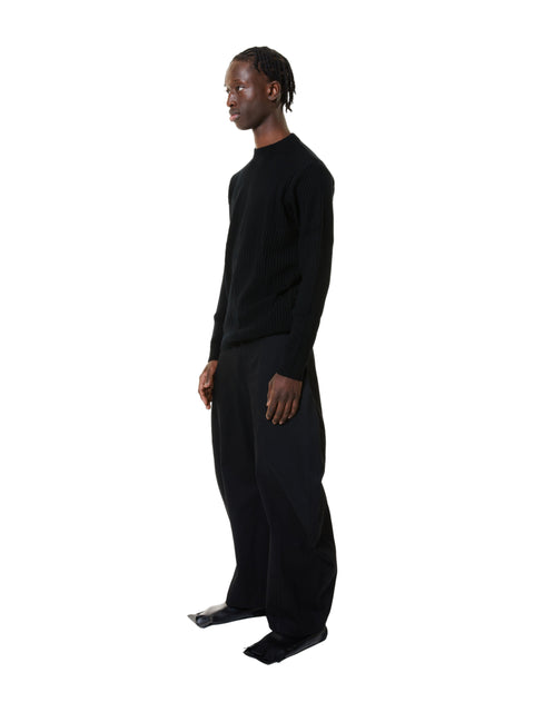 Person wearing a black outfit on a white background