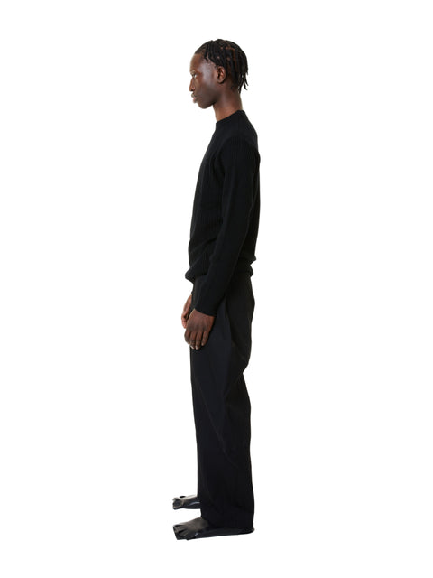 Person wearing a black outfit on a white background