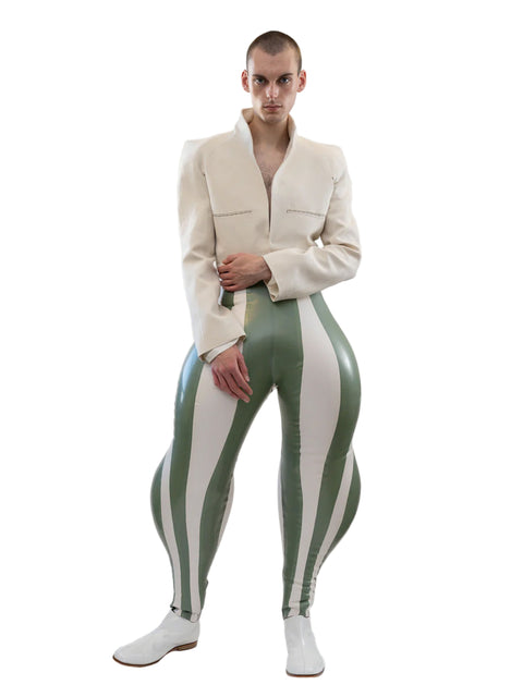 Person wearing a white jacket and green and white striped pants on a white background