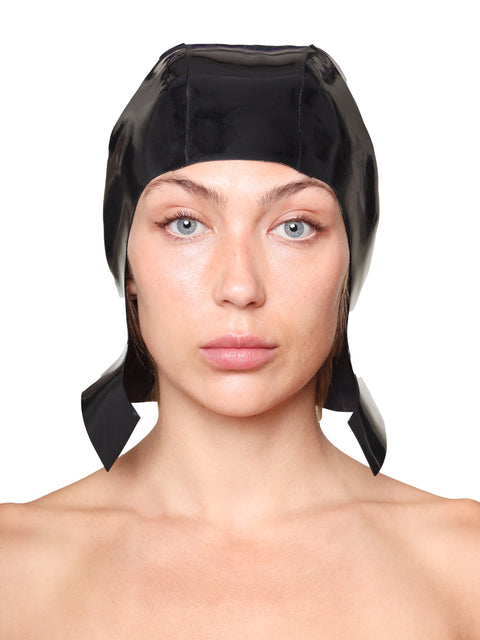 HARRI Black Cap with Ear Flaps made of shiny fabric worn by woman on white background
