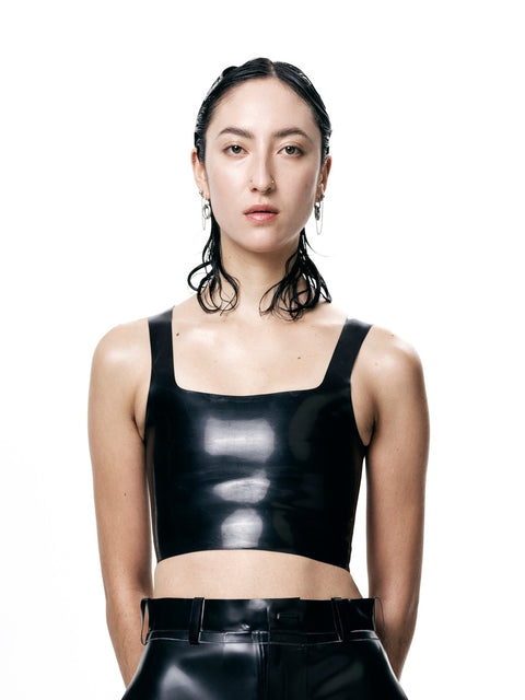 HARRI black cropped fitted tank top in shiny material worn by model with black pants