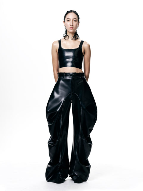 HARRI black cropped fitted tank top paired with high-waisted oversized black pants on model