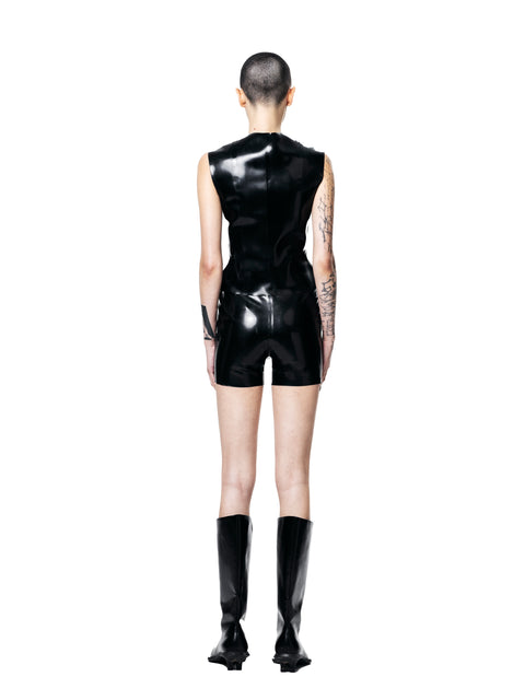 Back view of black fitted zip-up vest top by HARRI worn with matching shorts and black boots