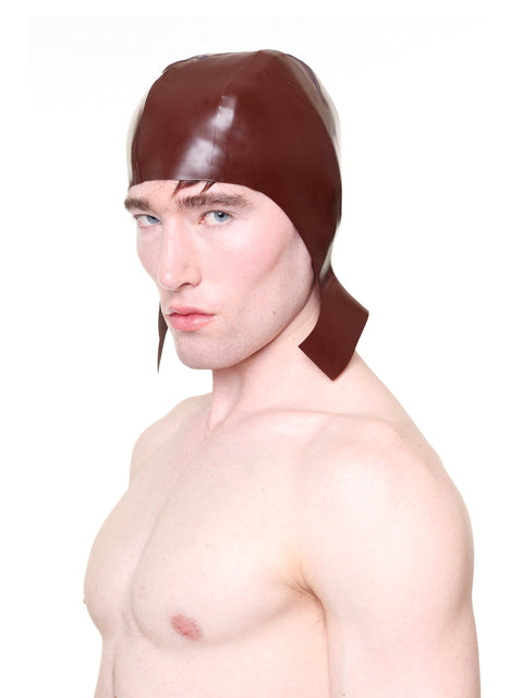 HARRI brown cap with ear flaps worn by shirtless male model in studio