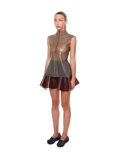 Woman wearing HARRI brown high waist flared shorts with a sleeveless top and black shoes