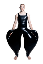 A person wearing black inflatable trousers shaped like a vase with handles at the waist with Tank top