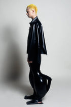Model wearing HARRI EXCLUSIVE inflatable latex trousers in shiny black with unique inflated lower leg design