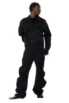 Person wearing a black denim outfit on a white background