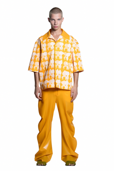Person wearing a HARRI yellow printed Shirt with deflated trousers on a white background