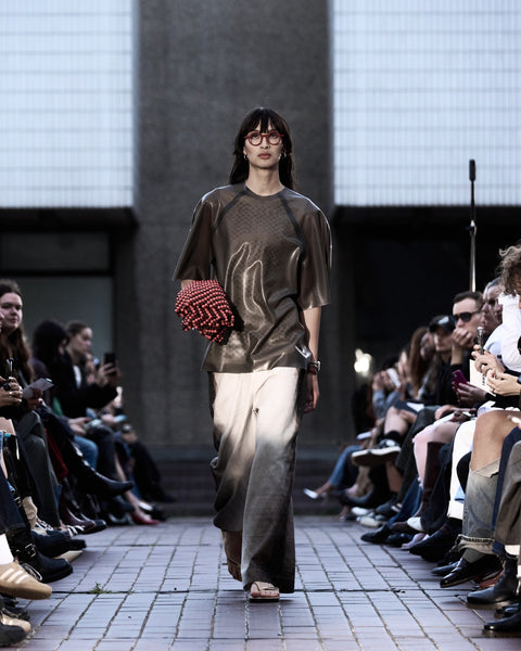 HARRI Laser cut tank top layered with oversized green t-shirt paired with printed white trousers