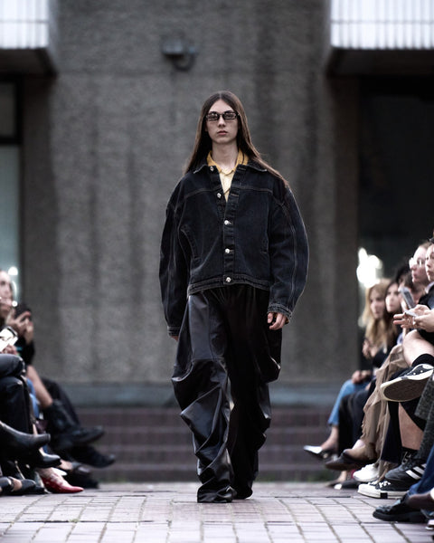 HARRI Yellow shirt layered under black denim jacket paired with black leather trousers