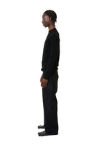 Person wearing a black outfit on a white background