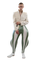 Person wearing a white jacket and green and white striped pants on a white background