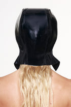 Back view of a black cap with ear flaps made of shiny material, worn over long blonde hair