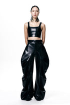 HARRI black cropped fitted tank top paired with high-waisted oversized black pants on model
