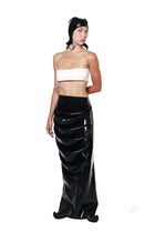 HARRI EXCLUSIVE Black Draped Deflated Maxi Skirt with glossy finish worn by woman in white bandeau top