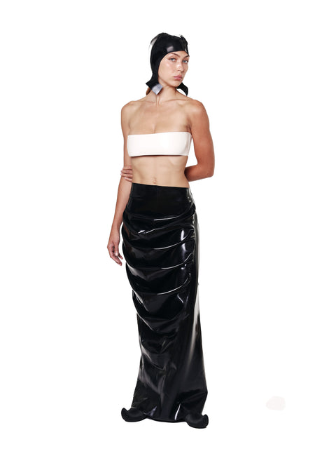 HARRI EXCLUSIVE Black Draped Deflated Maxi Skirt with glossy finish worn by woman in white bandeau top