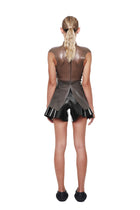 Back view of model wearing HARRI Black High Waist Flared Shorts with ruffle detail