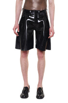 Black Knee Length Pleated Shorts by HARRI made of shiny material worn with black shoes