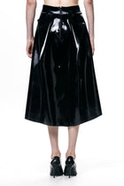 HARRI black pleated skirt in shiny fabric with back zipper detail worn with black heels