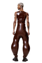 Back view of model wearing HARRI EXCLUSIVE Brown Alien Legs Inflatable Trousers with glossy finish