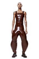 Model wearing HARRI EXCLUSIVE Brown Alien Legs Inflatable Trousers with matching top and black shoes