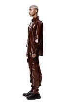 HARRI EXCLUSIVE Brown Alien Legs Inflatable Trousers worn with matching shiny brown shirt and black shoes