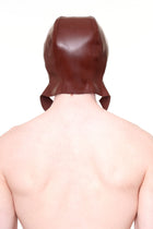 Back view of a person wearing a brown cap with ear flaps made of smooth material by HARRI