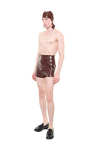 Male model wearing brown high waist essential biker shorts by HARRI paired with black shoes