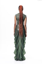 Back view of model wearing Green High Neck Draped Maxi Dress by HARRI EXCLUSIVE with long layered fabric design
