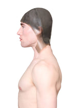 Profile of a shirtless man wearing a grey cap with ear flaps made by HARRI