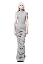 Person wearing a sleeveless gray dress on a white background