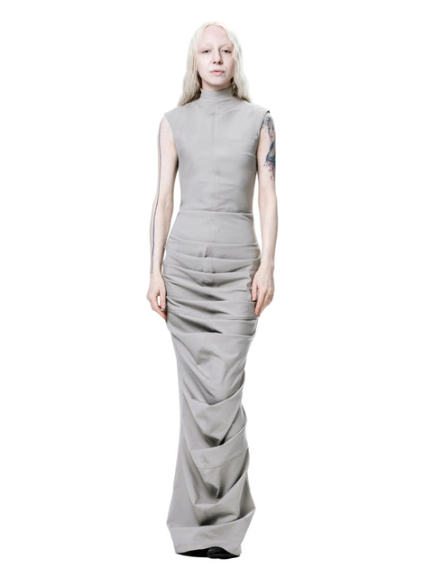 Person wearing a sleeveless gray dress on a white background