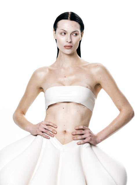 Woman wearing white HARRI Tube Top paired with a voluminous white skirt on a white background