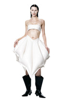 Model wearing HARRI Tube Top in white paired with an avant-garde skirt and black boots