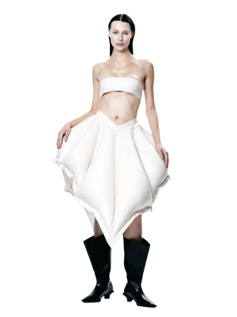 Model wearing HARRI Tube Top in white paired with an avant-garde skirt and black boots