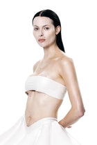 Model wearing white HARRI Tube Top paired with flowing white skirt on white background
